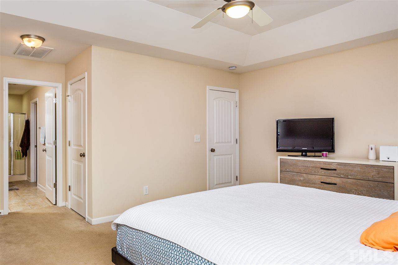 2410 Memory Ridge Drive Raleigh, NC 27606 - Photo 11 of 20 a bedroom with a bed and a flat screen tv
