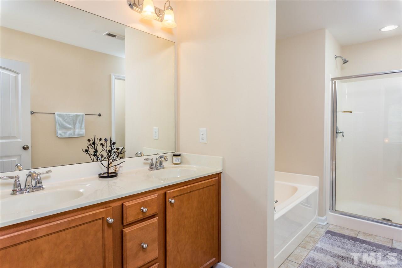 2410 Memory Ridge Drive Raleigh, NC 27606 - Photo 12 of 20 a bathroom with 2 sink tub and a mirror