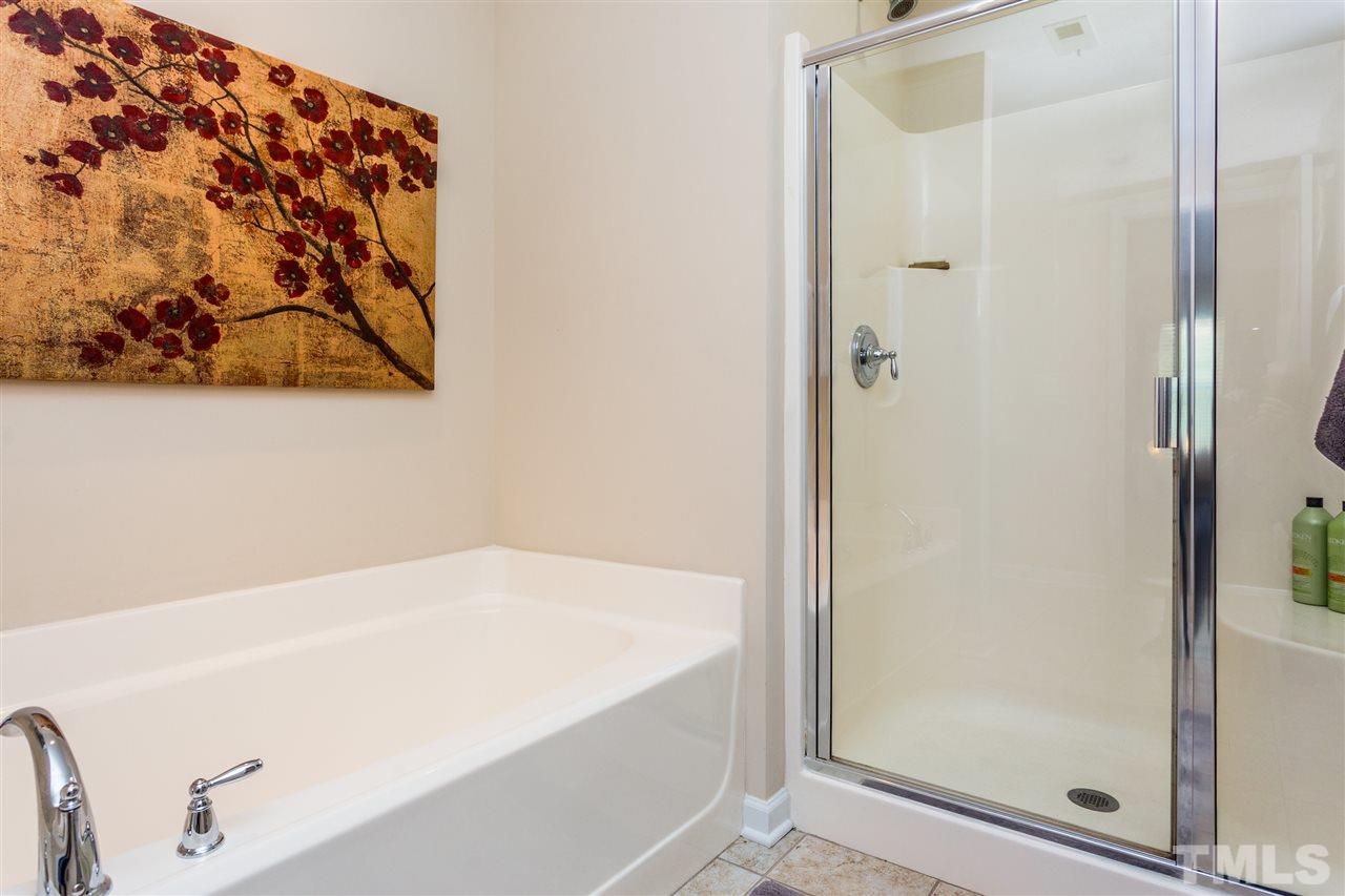 2410 Memory Ridge Drive Raleigh, NC 27606 - Photo 13 of 20 a bathroom with a bathtub and shower