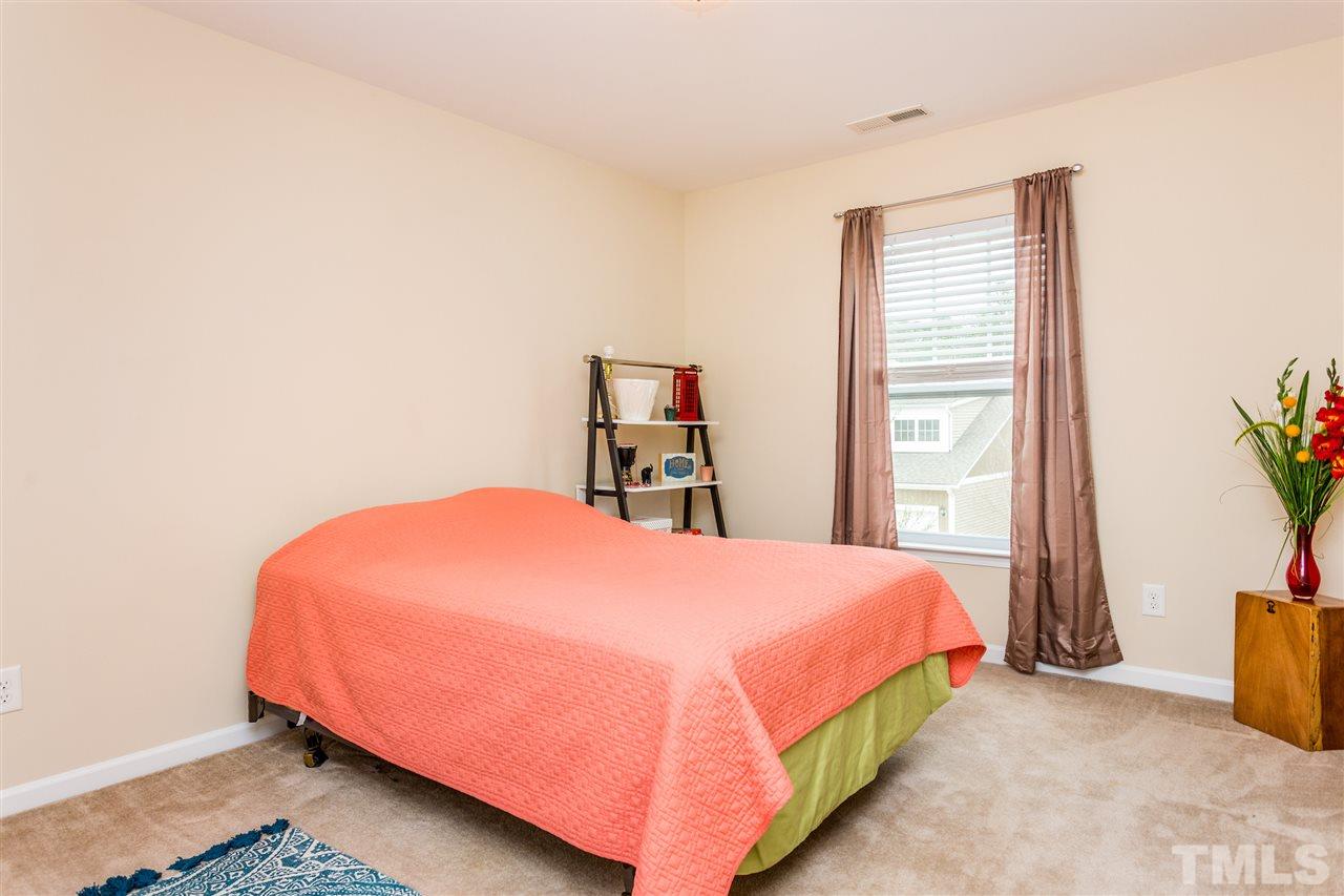 2410 Memory Ridge Drive Raleigh, NC 27606 - Photo 14 of 20 a bedroom with a bed and a large window