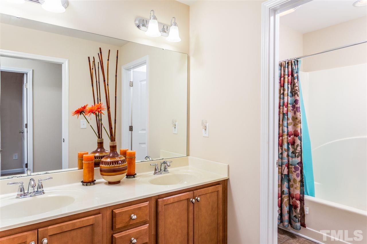 2410 Memory Ridge Drive Raleigh, NC 27606 - Photo 16 of 20 a bathroom with a double vanity sink and a mirror
