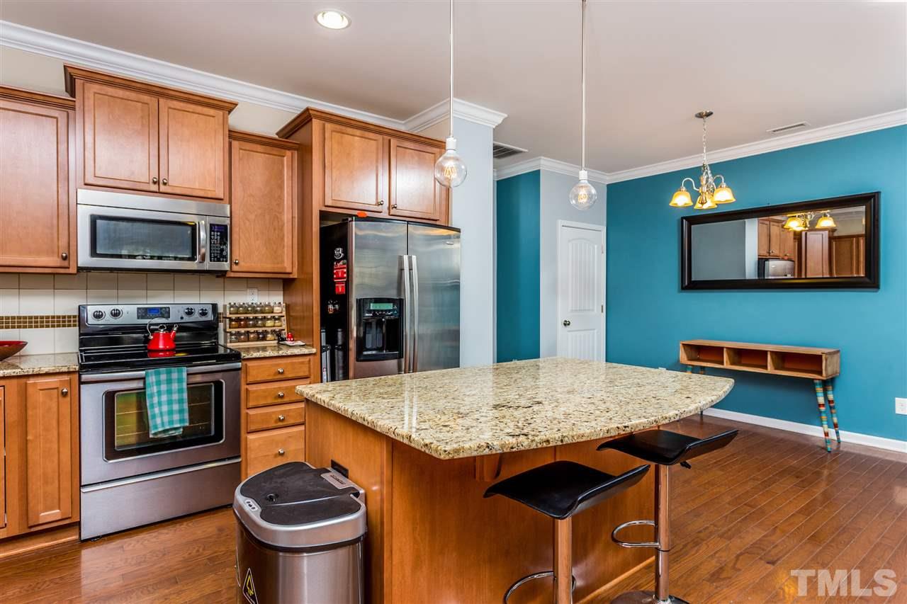 2410 Memory Ridge Drive Raleigh, NC 27606 - Photo 3 of 20 a kitchen with stainless steel appliances granite countertop a stove a refrigerator and a stove top oven