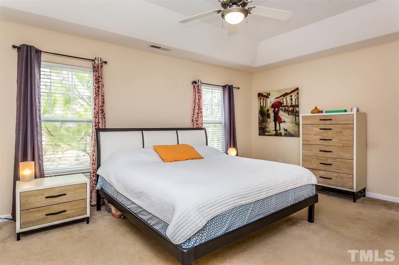 2410 Memory Ridge Drive Raleigh, NC 27606 - Photo 10 of 20 a bedroom with a bed and a chandelier