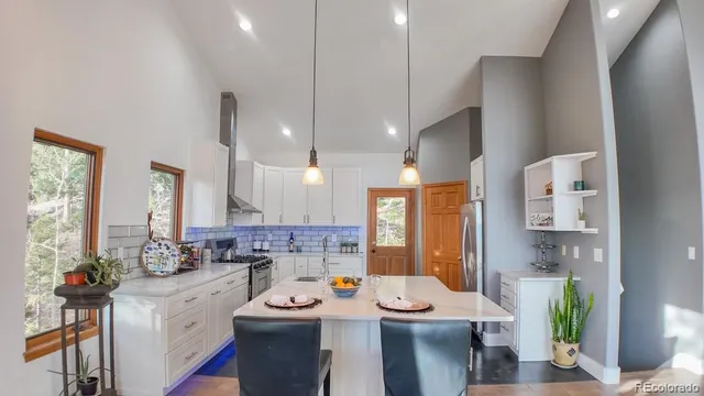 a large kitchen with sink a counter space and living room view