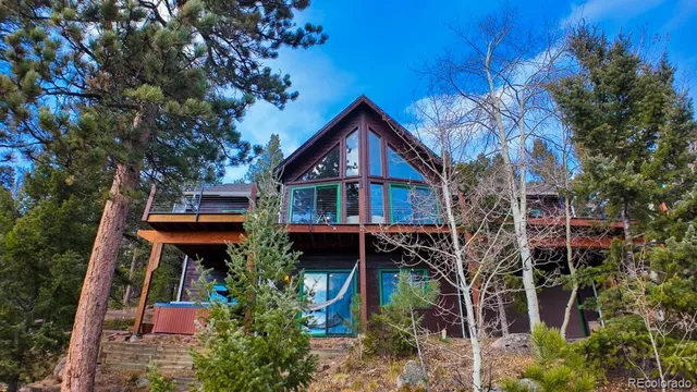 a front view of house with yard and trees around