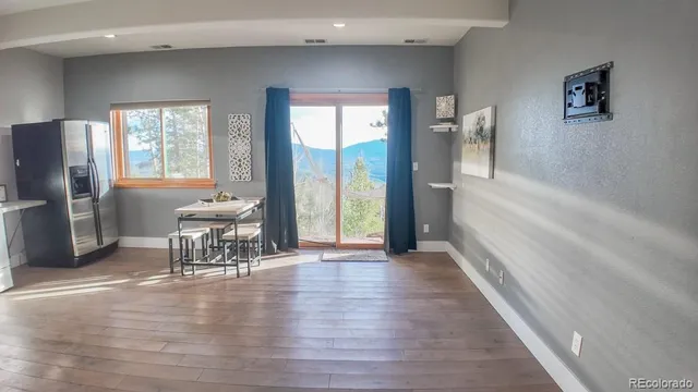 a view of a livingroom with furniture window and wooden floor