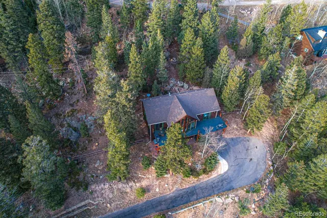 an aerial view of a house with yard and outdoor seating