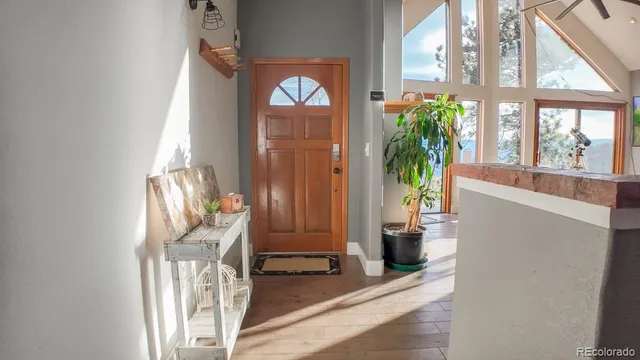 a view of an entryway with wooden floor