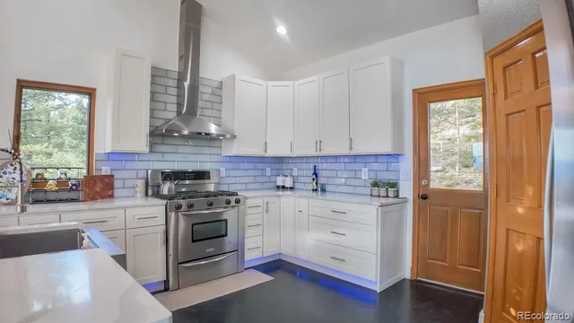 a stove top oven sitting inside of a kitchen