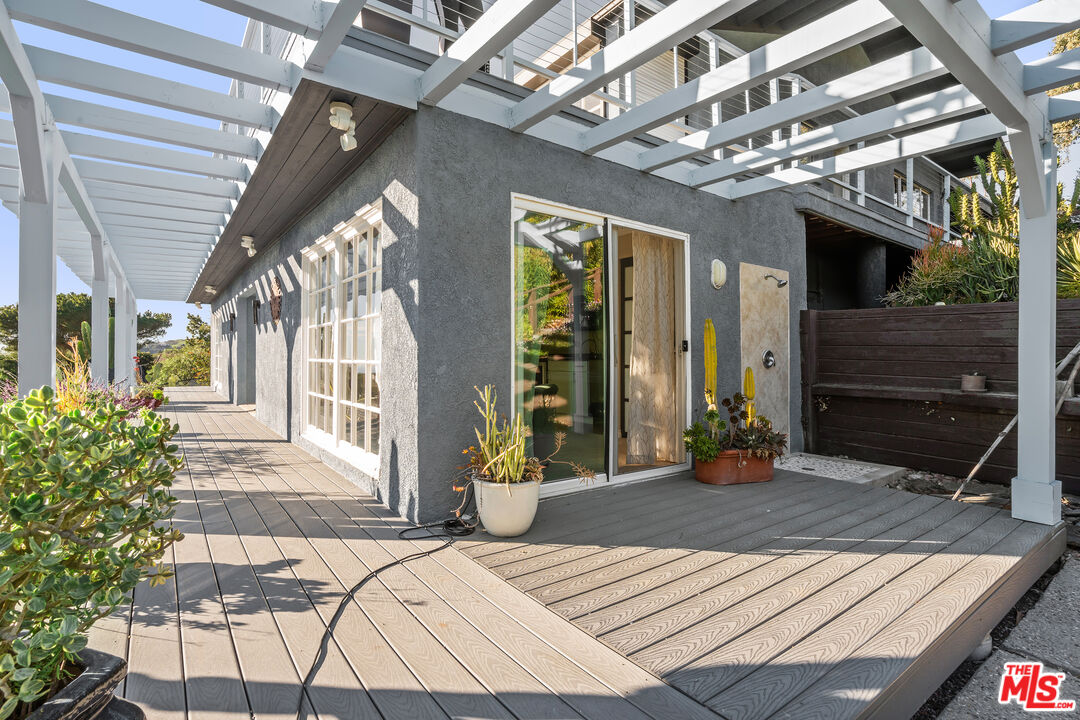 9402 Houston Road Malibu, CA 90265 - Photo 11 of 30 a view of a porch with furniture and chandelier