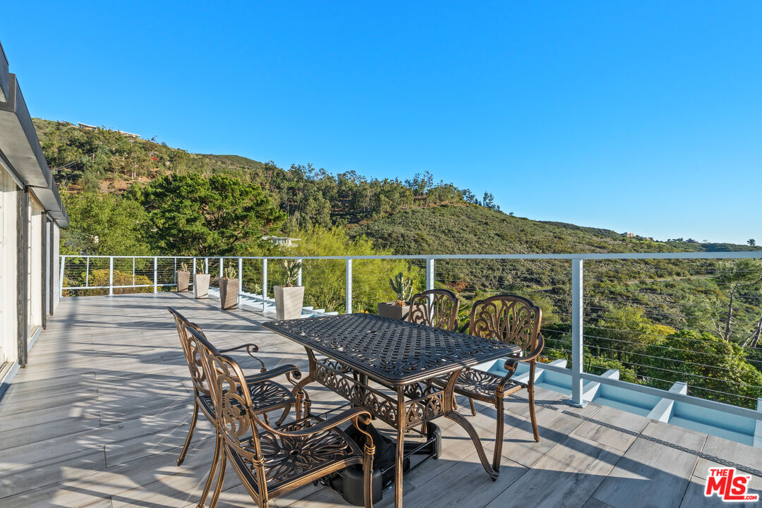9402 Houston Road Malibu, CA 90265 - Photo 12 of 30 a view of a chairs and table on the wooden floor