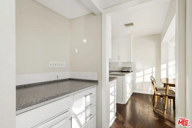 a kitchen with appliances cabinets and a window