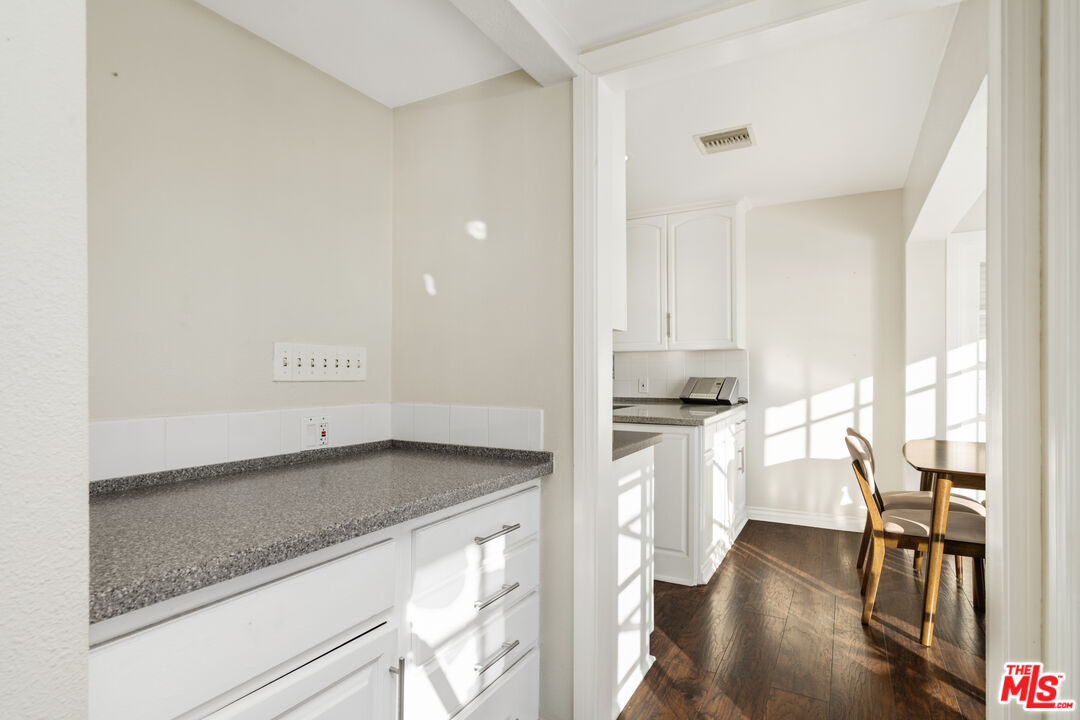 9402 Houston Road Malibu, CA 90265 - Photo 24 of 30 a kitchen with granite countertop a stove and a refrigerator