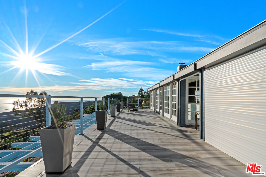 9402 Houston Road Malibu, CA 90265 - Photo 8 of 30 a patio with table and chairs