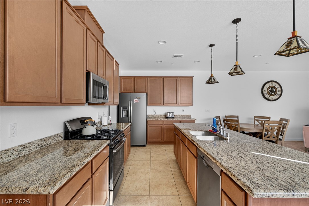 1100 East Sunset Road Henderson, NV 89011 - Photo 15 of 58 Well-appointed kitchen featuring abundant cabinetry and granite countertops, seamlessly flowing into a dining space.
