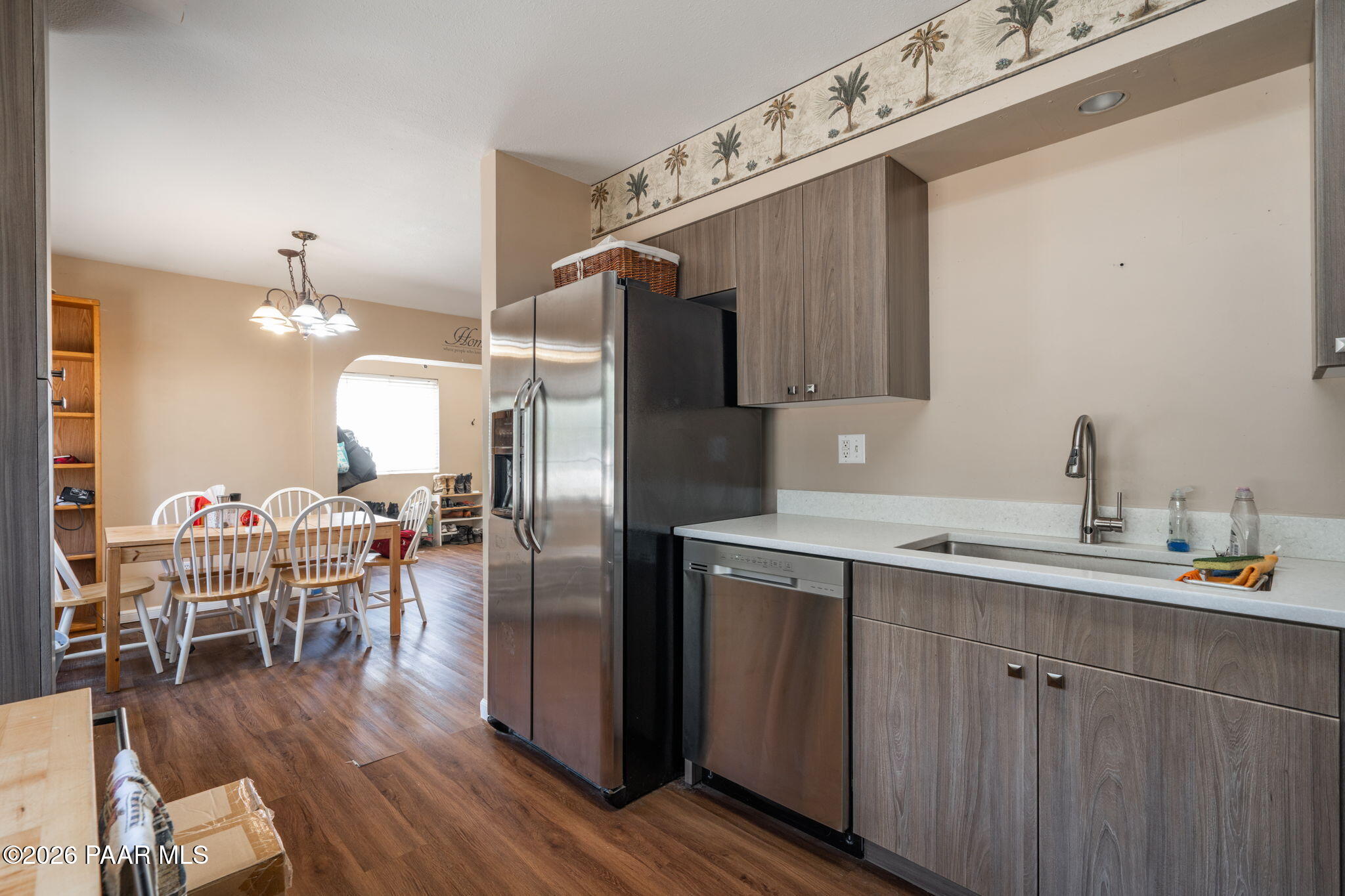 1710 Grandview Road Prescott, AZ 86305 - Photo 10 of 47 a kitchen with stainless steel appliances a dining table chairs refrigerator and sink