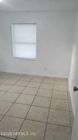 a view of kitchen with granite countertop cabinets and white appliances