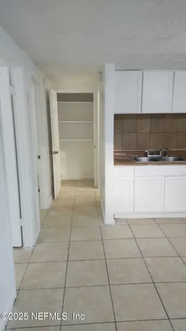 a view of a livingroom with an empty space and a window