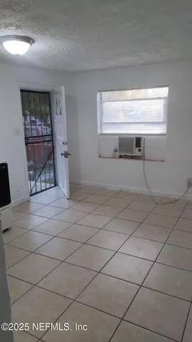 a view of a livingroom with wooden floor and a window