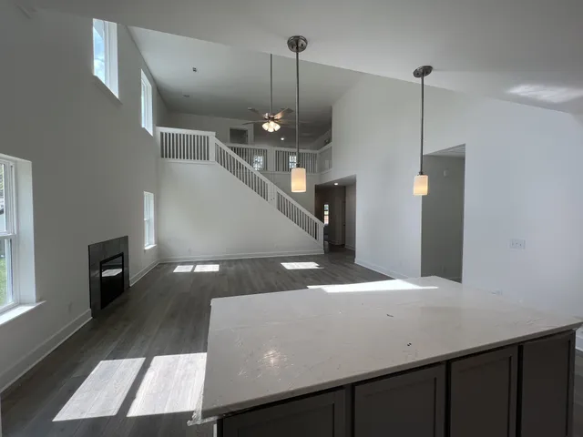 a kitchen with a sink a refrigerator and wooden floor