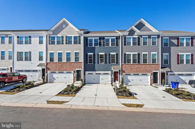 a view of a car park in front of a brick house
