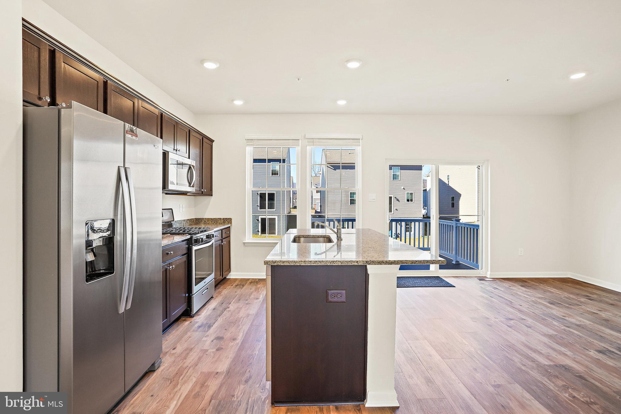 1271 Apollo Drive Frederick, MD 21702 - Photo 11 of 42 a kitchen with stainless steel appliances granite countertop a refrigerator a stove and a sink