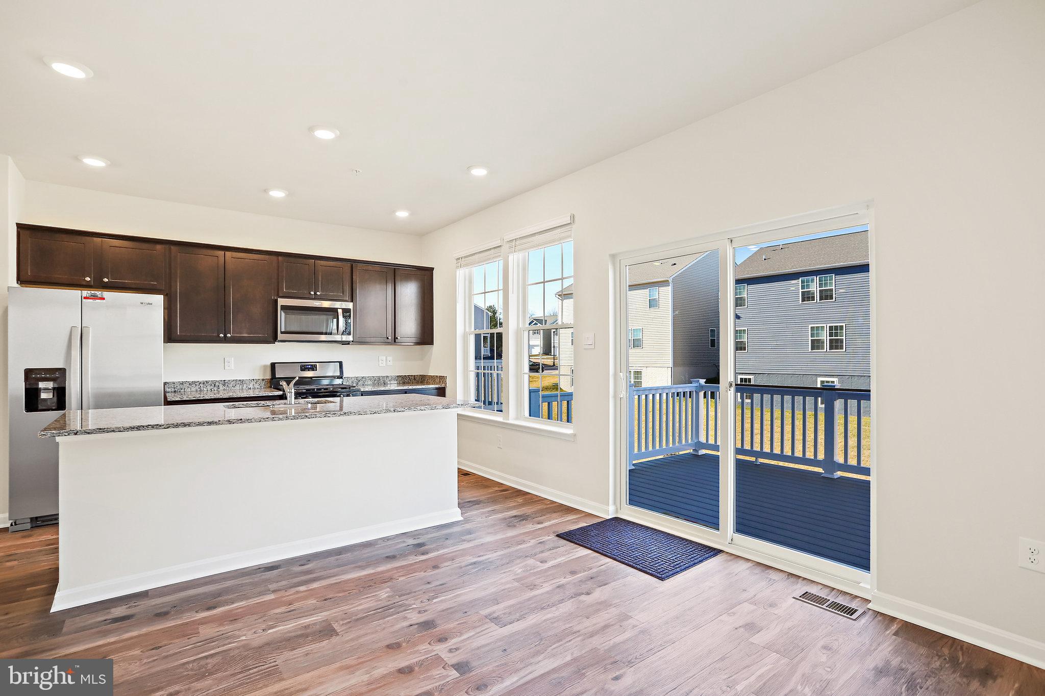 1271 Apollo Drive Frederick, MD 21702 - Photo 15 of 42 a kitchen with stainless steel appliances a refrigerator and a stove top oven
