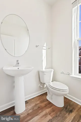 a bathroom with a sink toilet and a mirror
