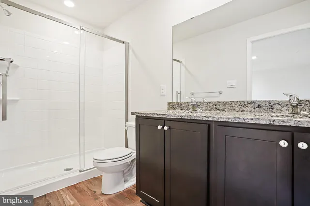 a bathroom with a toilet a sink and shower