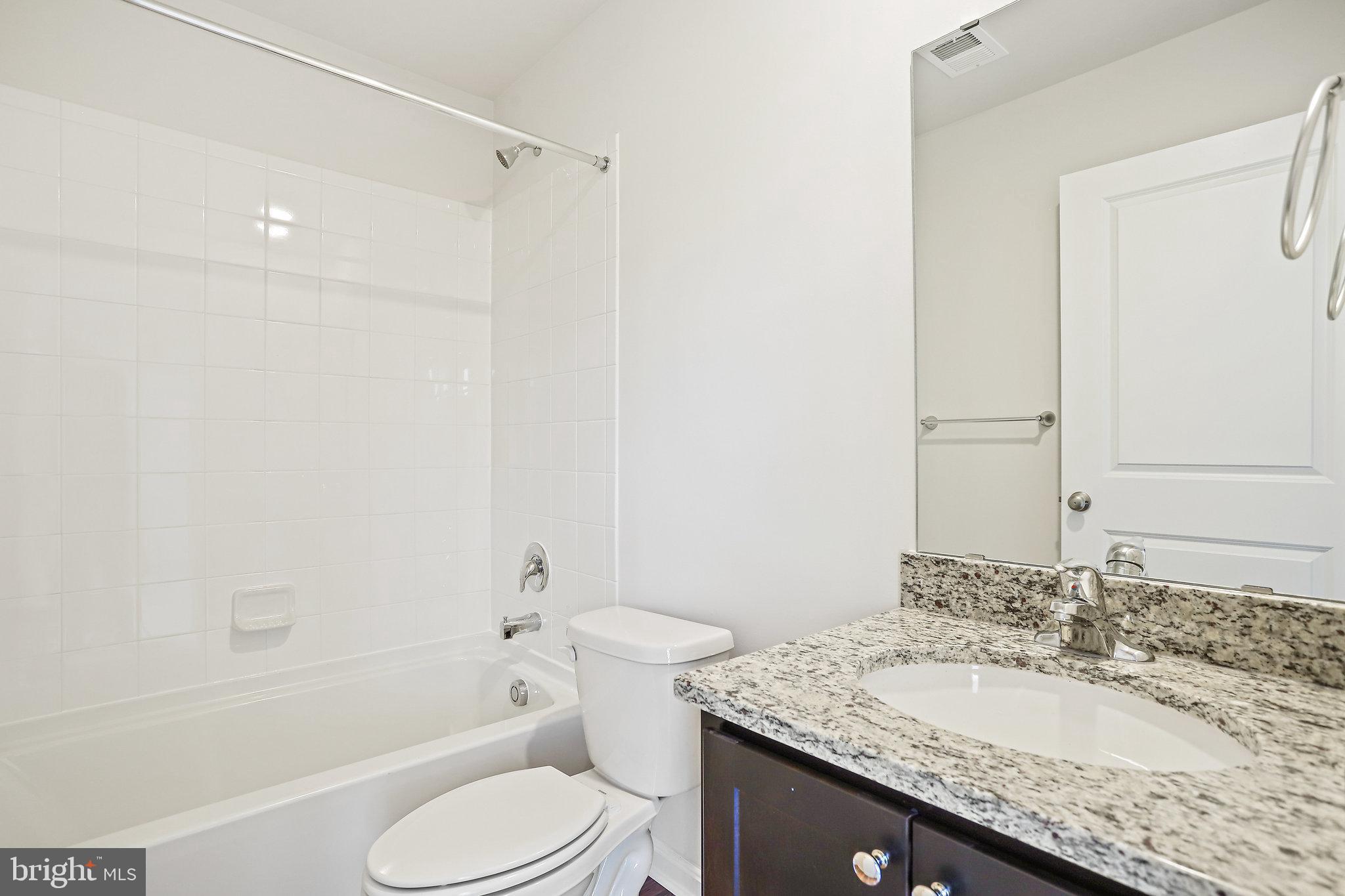 1271 Apollo Drive Frederick, MD 21702 - Photo 37 of 42 a bathroom with a granite countertop sink toilet and shower