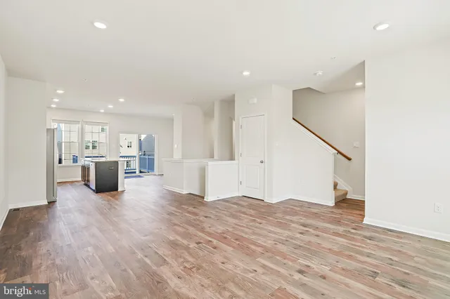 a view of a kitchen with a sink and a refrigerator