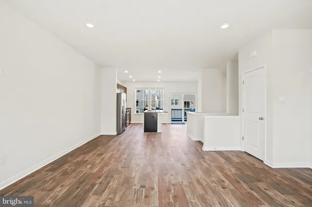 a view of a kitchen with wooden floor