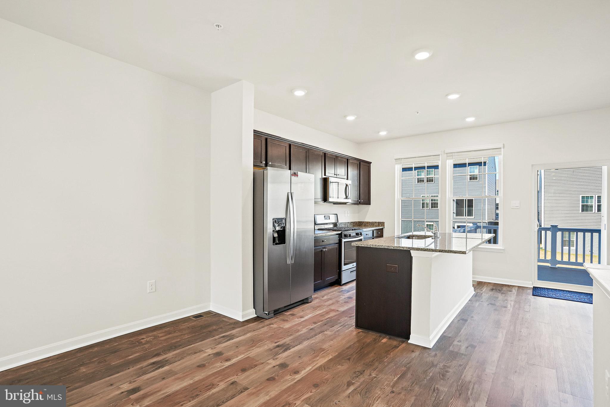 1271 Apollo Drive Frederick, MD 21702 - Photo 10 of 42 a kitchen with stainless steel appliances a refrigerator and wooden floor