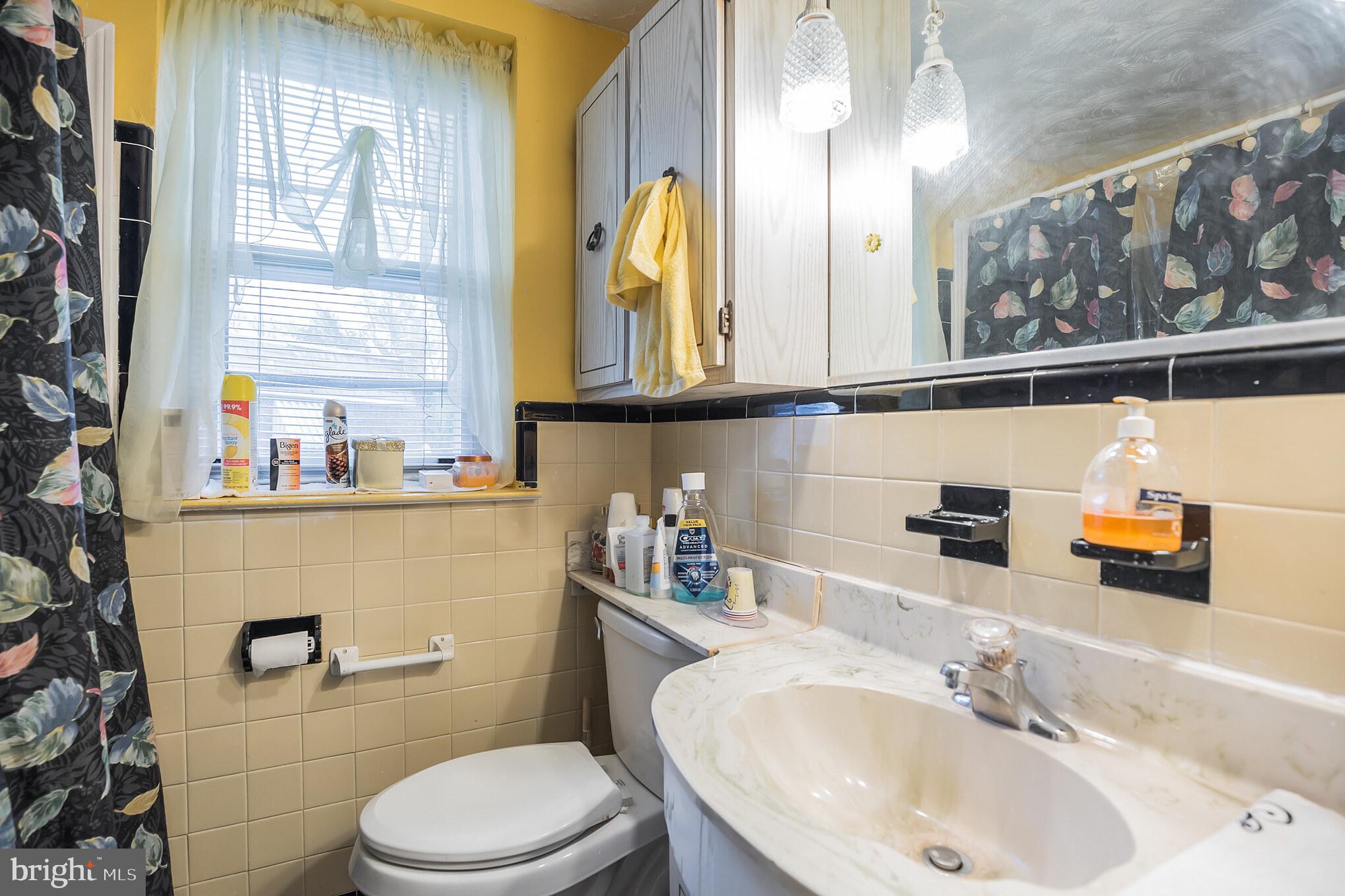 1024 South Lynbrook Road Darby, PA 19023 - Photo 15 of 29 a bathroom with a sink a toilet and a mirror