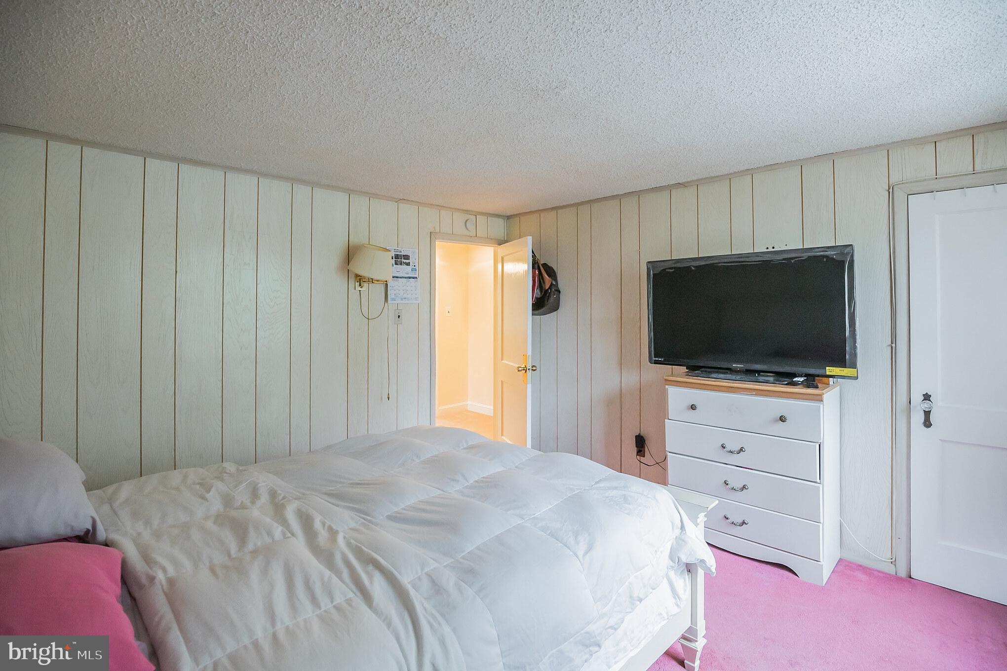 1024 South Lynbrook Road Darby, PA 19023 - Photo 17 of 29 a bedroom with a bed and a flat screen tv in a bedroom