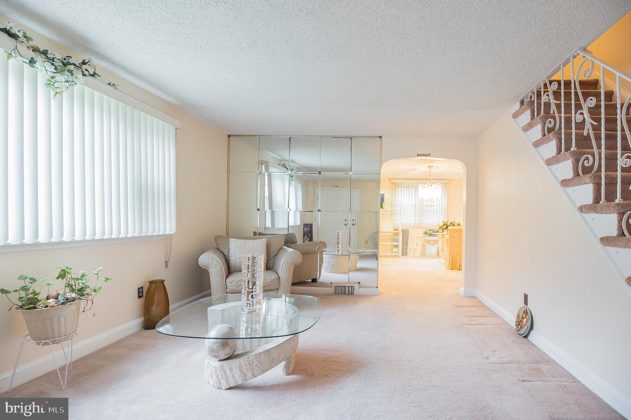 1024 South Lynbrook Road Darby, PA 19023 - Photo 4 of 29 a living room with furniture and a chandelier
