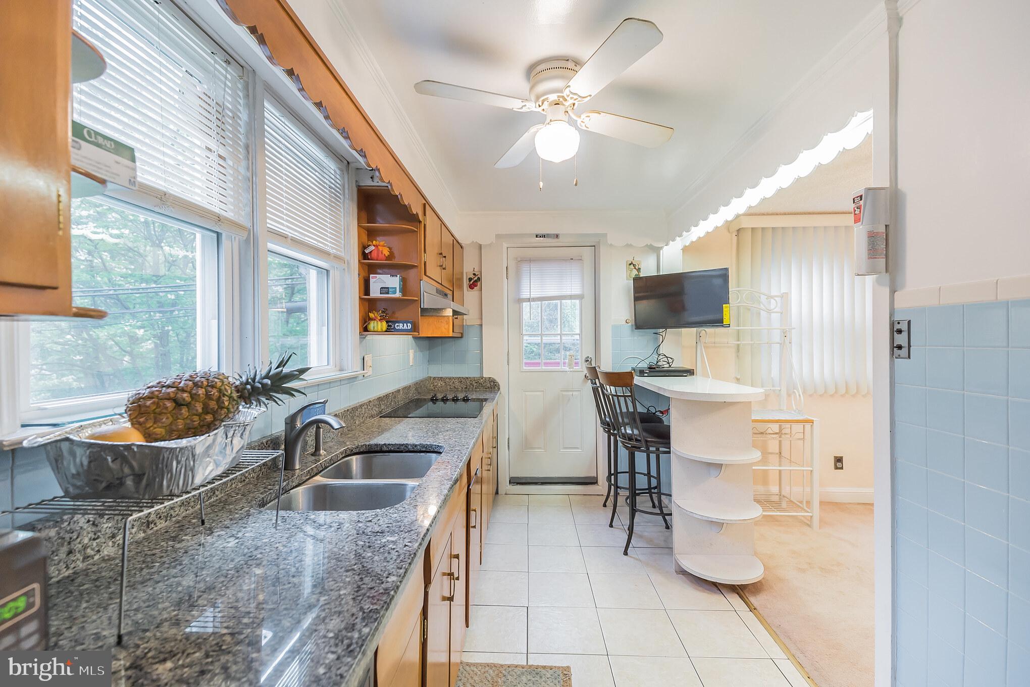 1024 South Lynbrook Road Darby, PA 19023 - Photo 5 of 29 a kitchen with a sink a stove and chairs