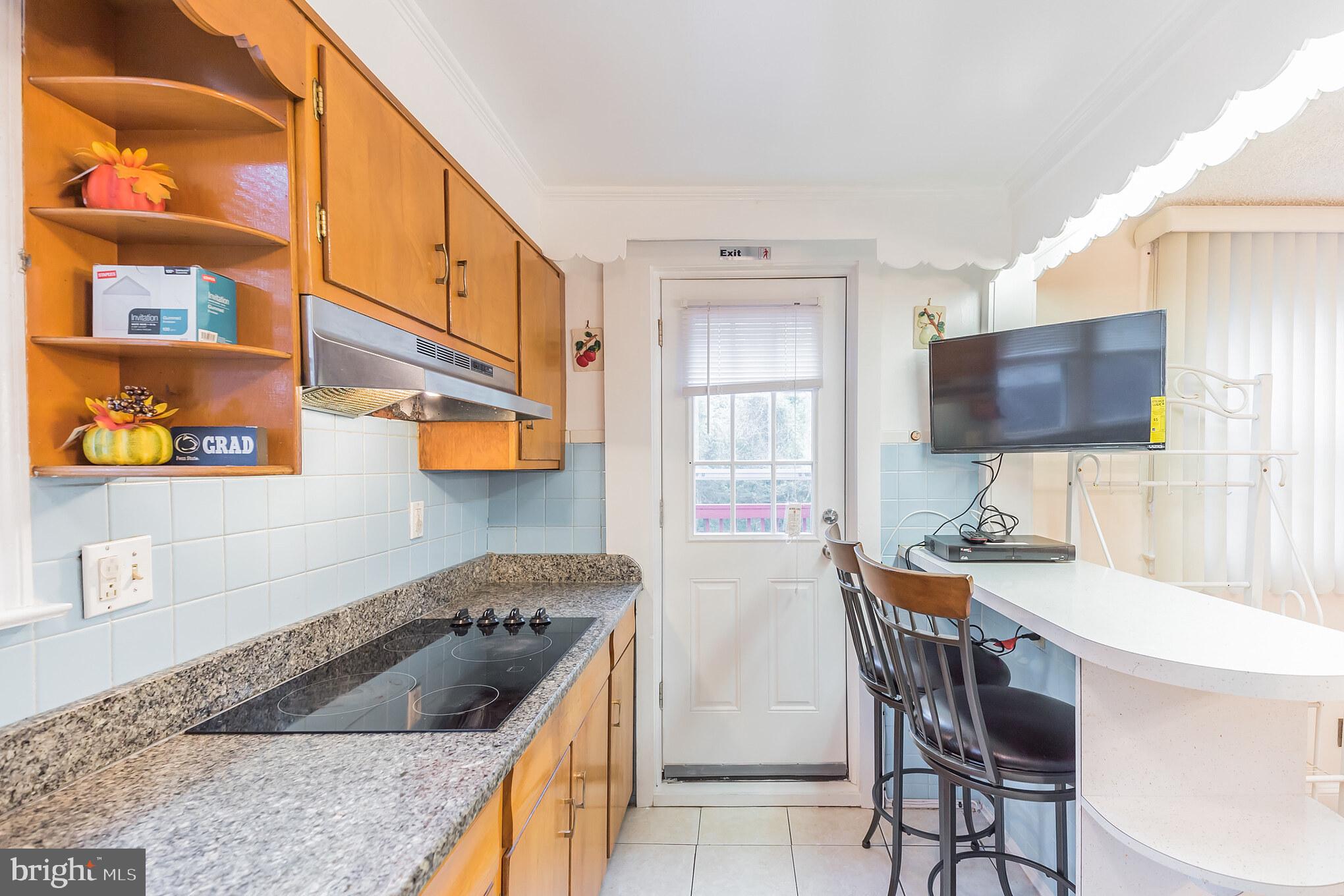 1024 South Lynbrook Road Darby, PA 19023 - Photo 8 of 29 a kitchen with stainless steel appliances granite countertop a sink and a stove