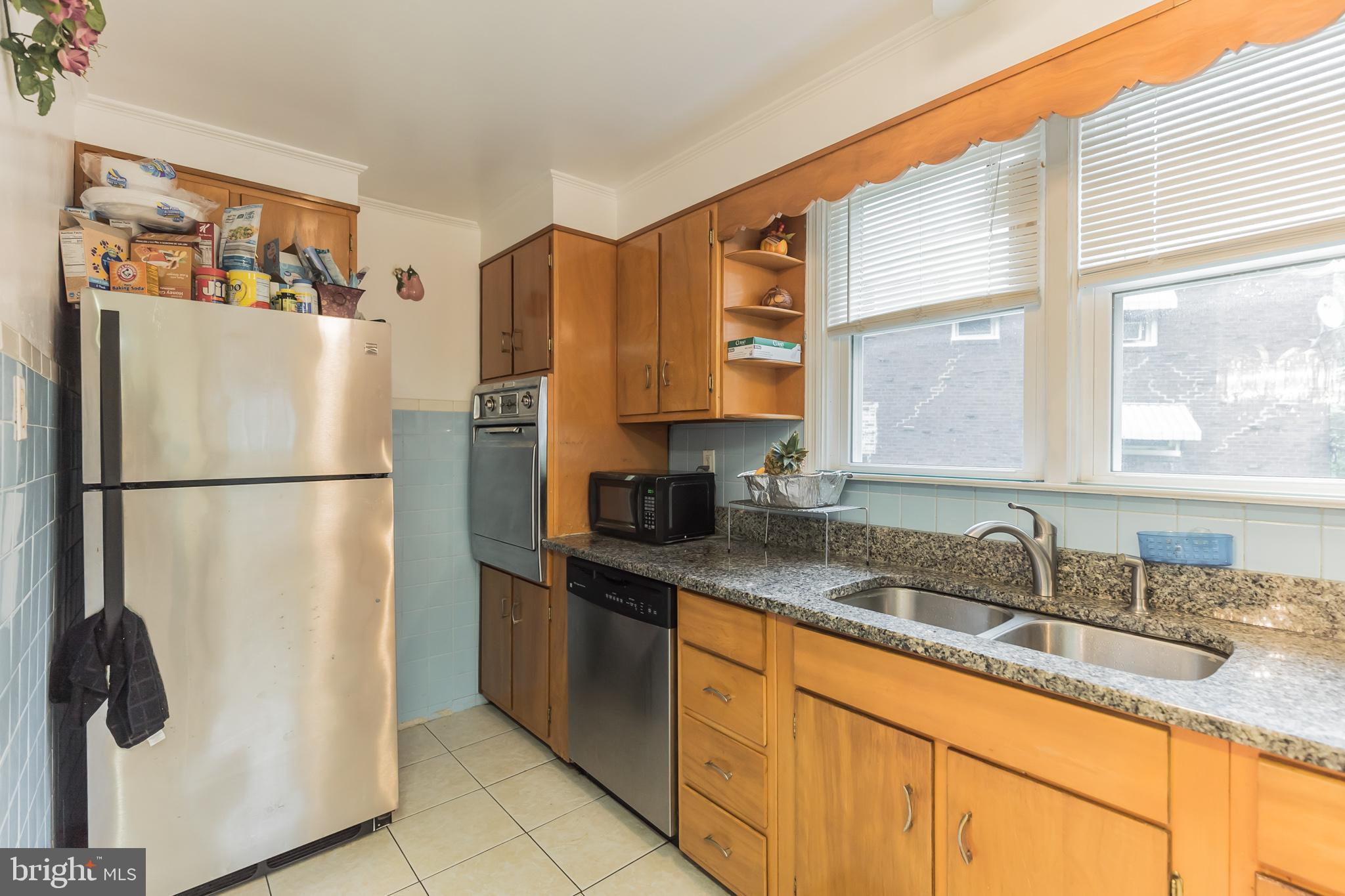 1024 South Lynbrook Road Darby, PA 19023 - Photo 10 of 29 a kitchen with stainless steel appliances granite countertop a refrigerator and a sink