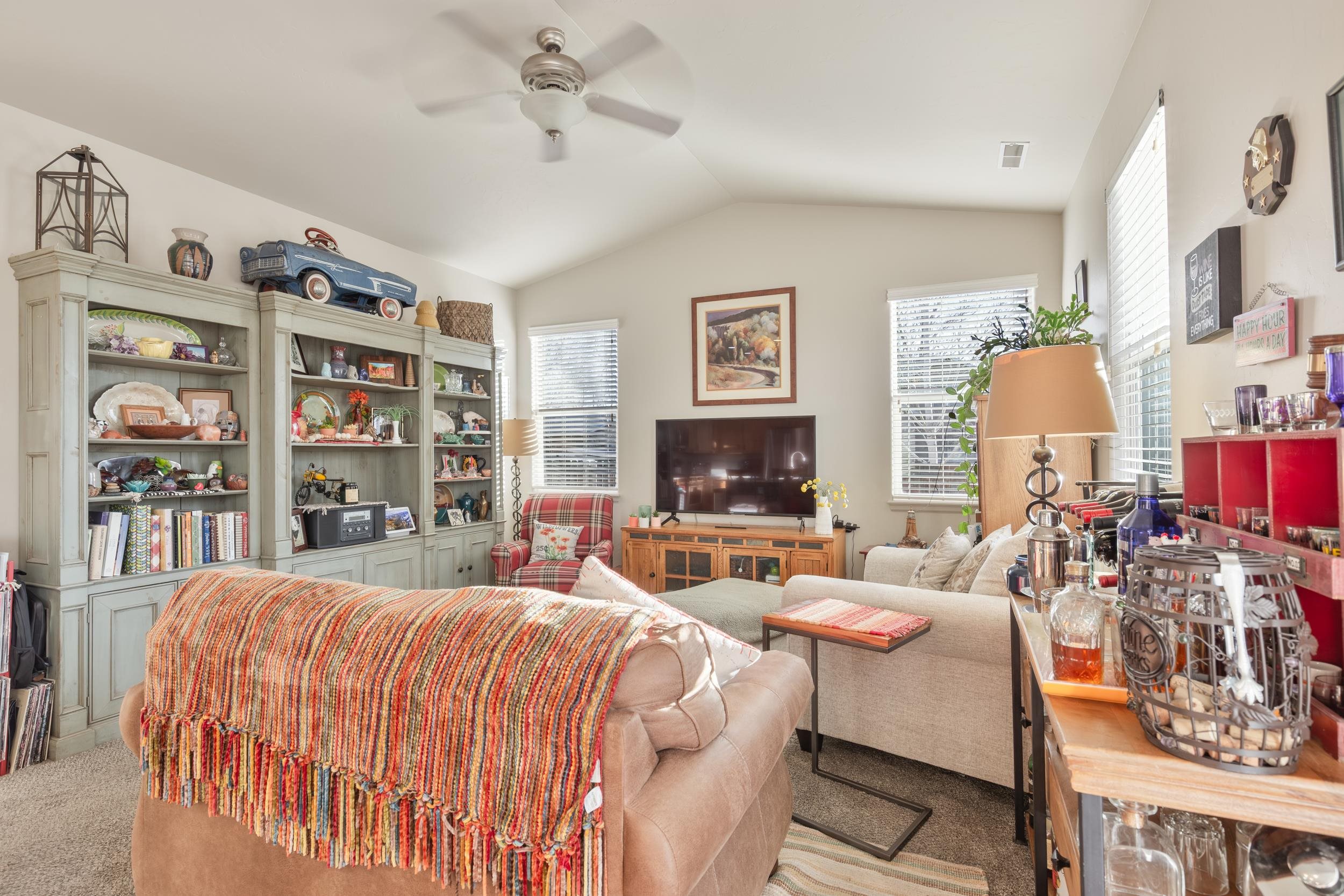3033 Prairie View Drive Grand Junction, CO 81504 - Photo 11 of 32 a bedroom with a bed a couch and bookshelf