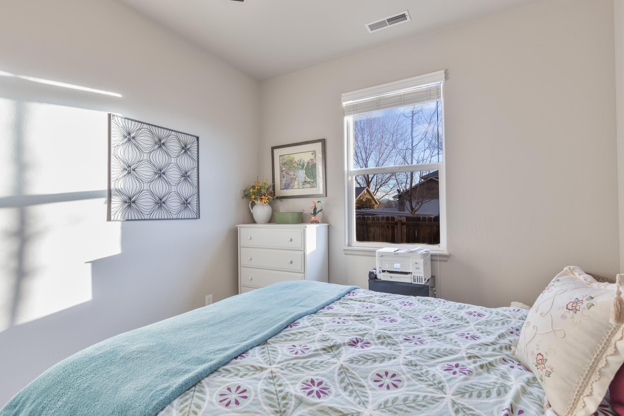 3033 Prairie View Drive Grand Junction, CO 81504 - Photo 14 of 32 a bedroom with a bed and tv