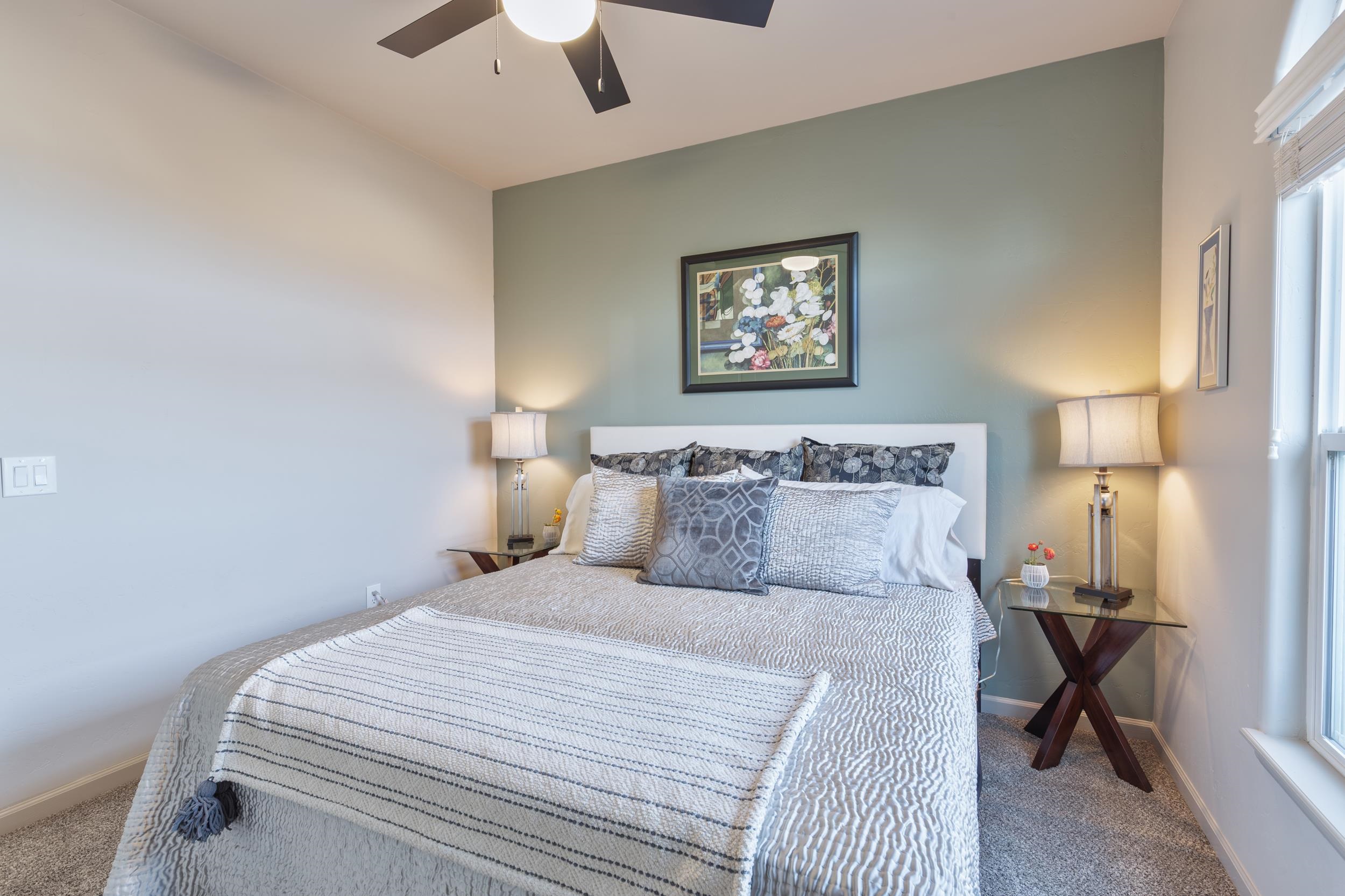 3033 Prairie View Drive Grand Junction, CO 81504 - Photo 19 of 32 a bedroom with a bed and a lamp on table
