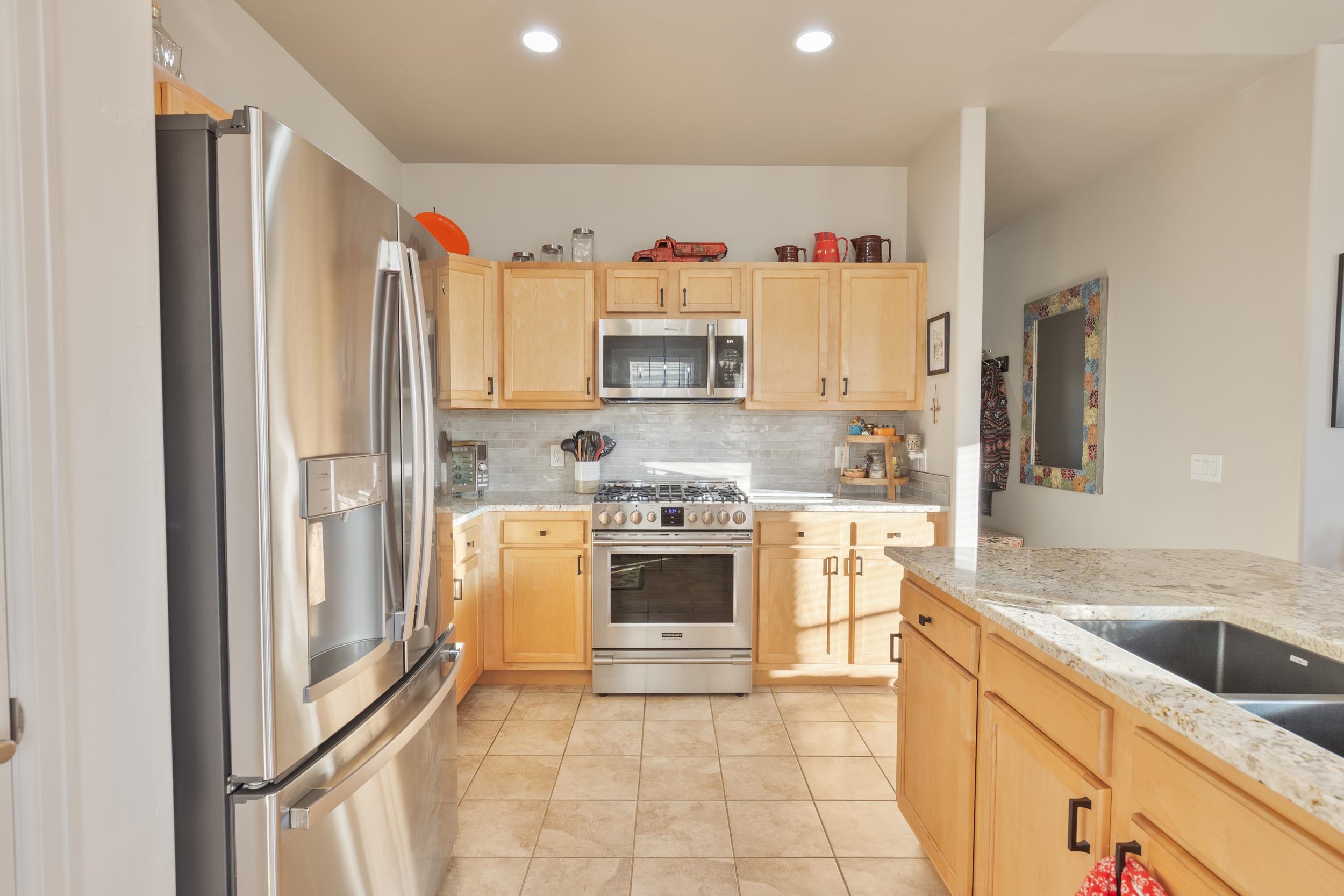 3033 Prairie View Drive Grand Junction, CO 81504 - Photo 8 of 32 a kitchen with stainless steel appliances granite countertop a refrigerator and a sink