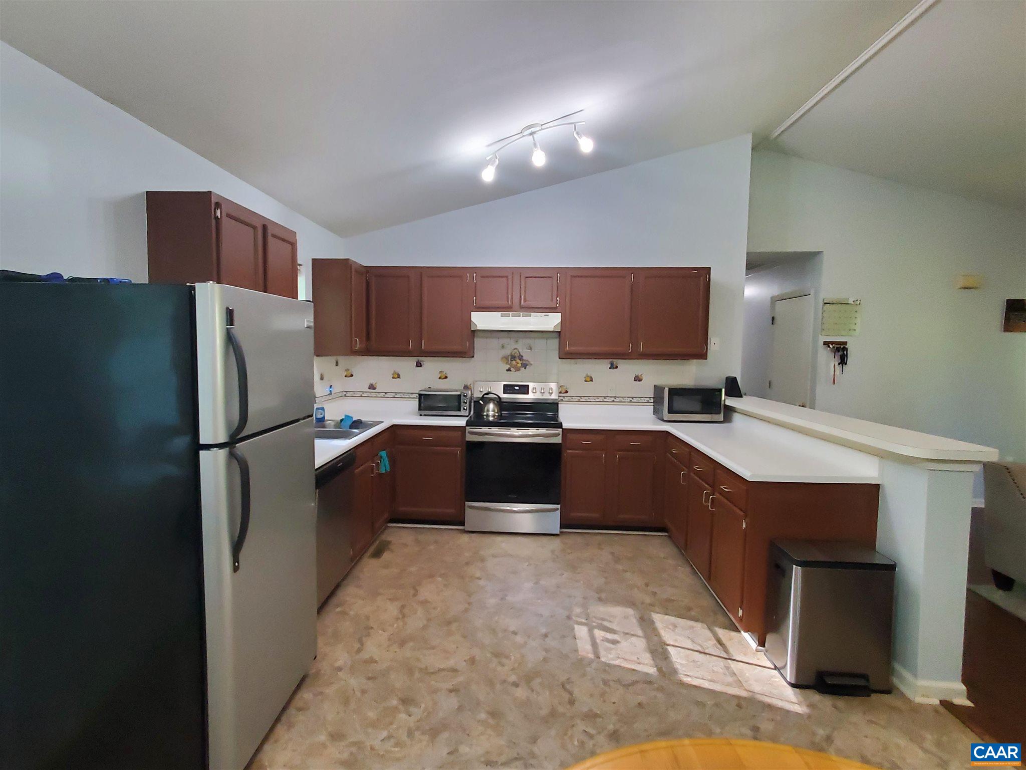 583 Jonquil Road Ruckersville, VA 22968 - Photo 9 of 14 a kitchen with granite countertop a refrigerator and a sink