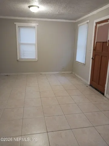 a view of an empty room and a window