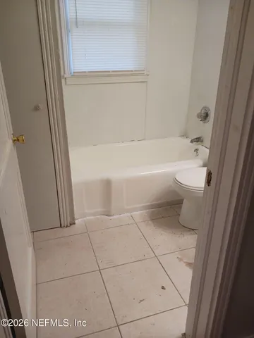a bathroom with a bathtub and toilet