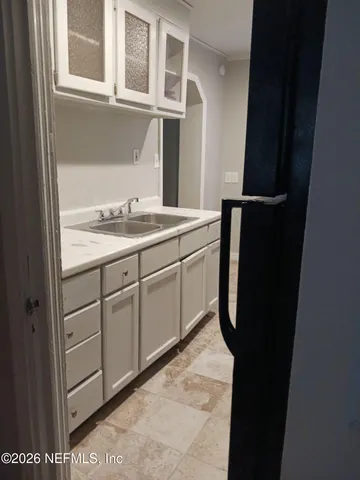 a kitchen with a sink and a refrigerator