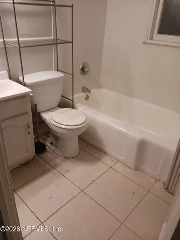 a bathroom with a toilet and a bathtub