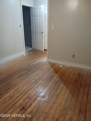 an empty room with wooden floor