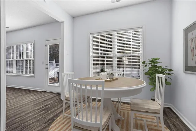 a view of a dining room with furniture and window